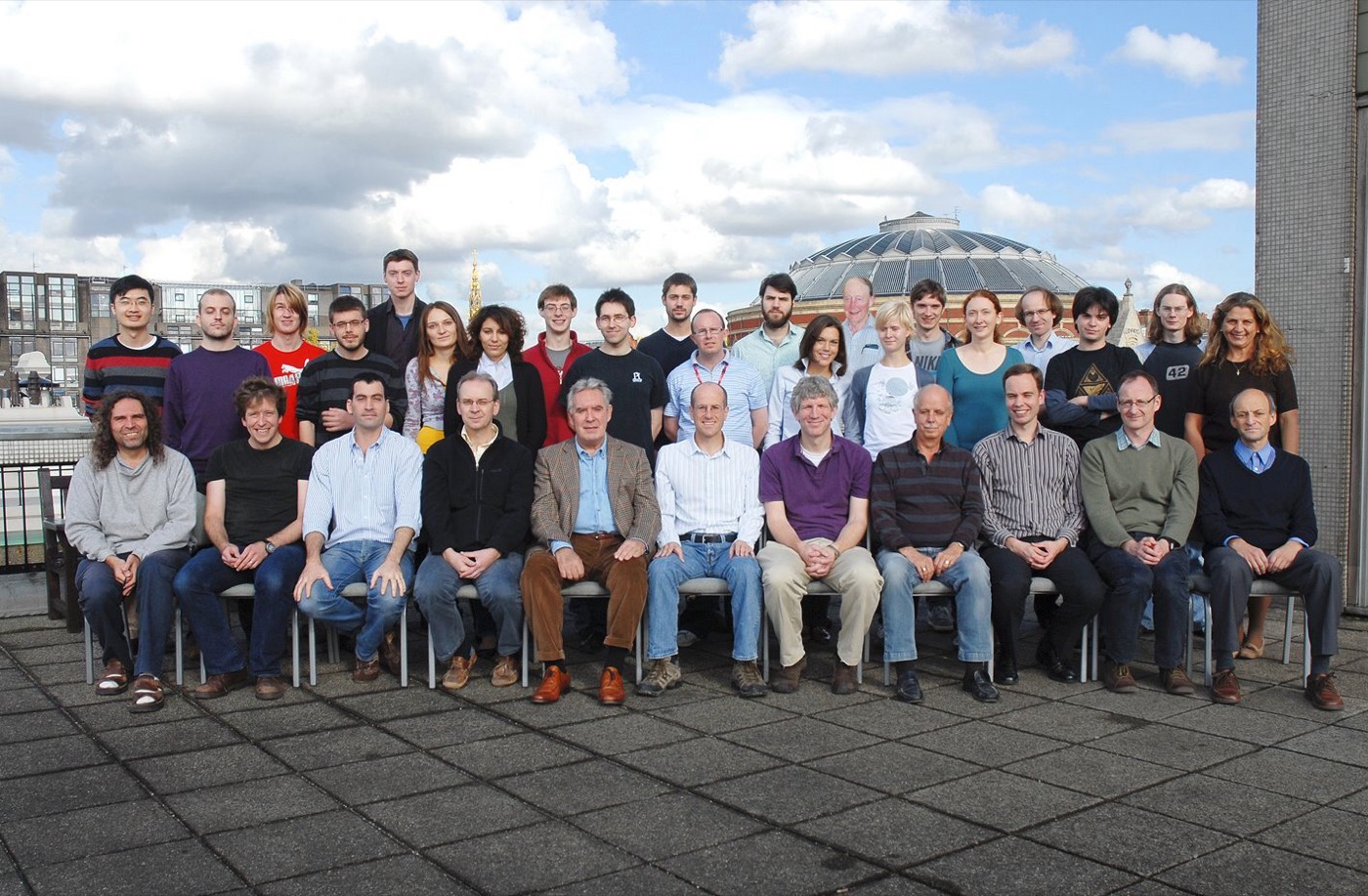 Group photo of the Theoretical Physics Group on a rooftop at Imperial College London, with the Royal Albert Hall behind