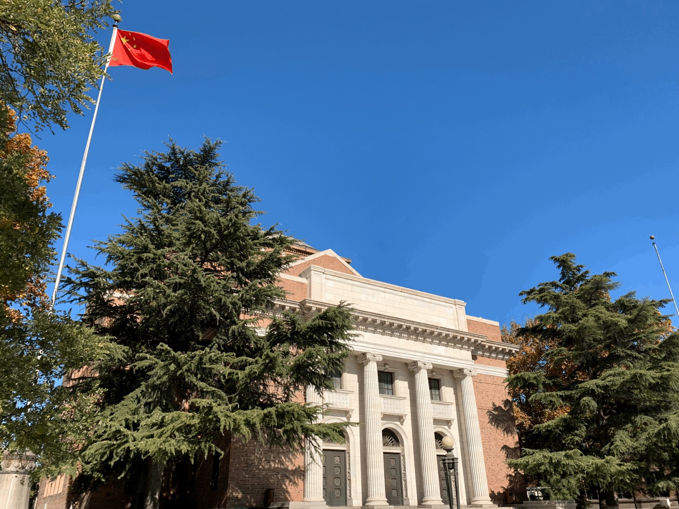 Historic building and flagpole on the Tsinghua University campus